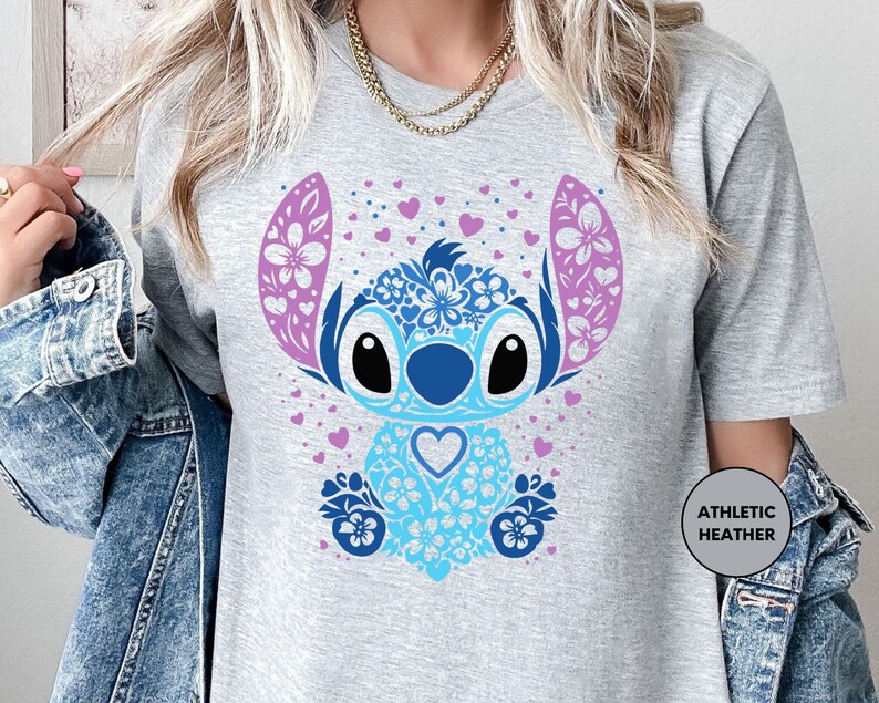 a woman wearing a t - shirt with a cartoon character on it