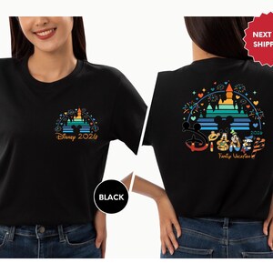 A woman wearing a black t-shirt with a Disney-themed design on the back.