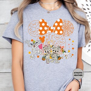 a woman wearing a mickey mouse t - shirt