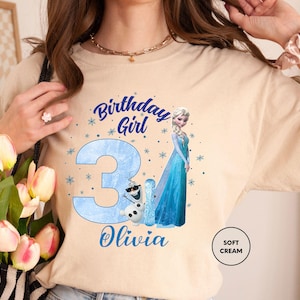 a woman in a birthday shirt holding a bouquet of tulips