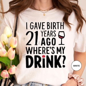 a woman wearing a t - shirt that says, i gave birth years 21 ago