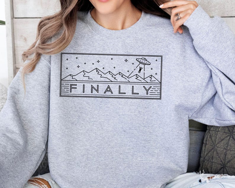 a woman wearing a sweatshirt with a graphic on it