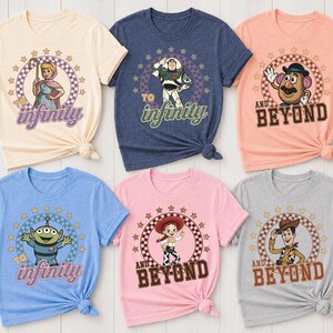 May include: Six short-sleeved t-shirts in cream, navy, peach, light blue, pink, and grey. Each shirt features a circular graphic with stars, a checkered border, and a character from the Toy Story franchise with the text To Infinity and Beyond.