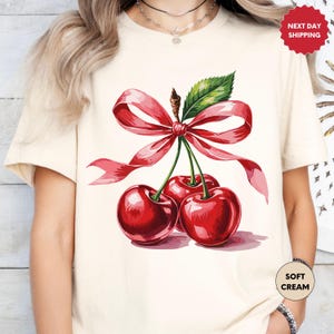 a woman wearing a t - shirt with cherries on it