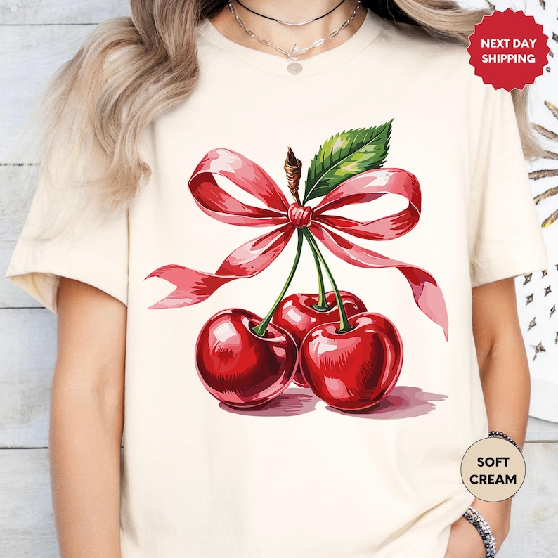 a woman wearing a t - shirt with cherries on it