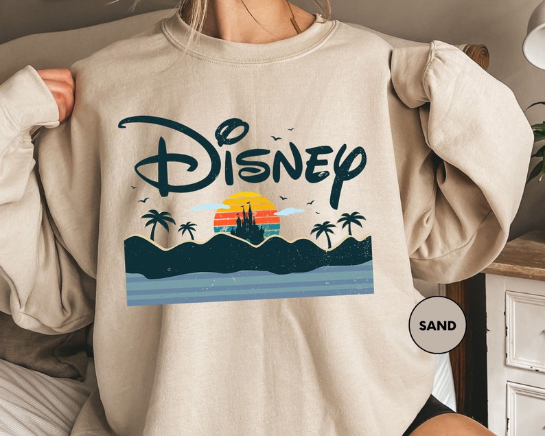 a woman wearing a sweatshirt with the disney logo on it
