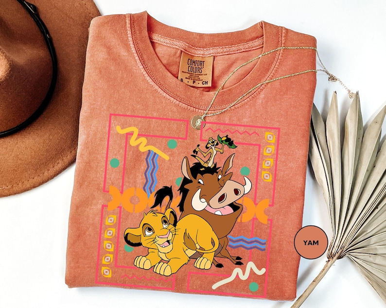 a t - shirt with a picture of a lion and a cow on it
