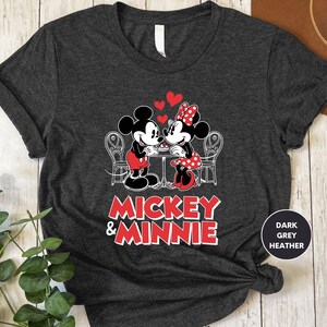 a mickey and minnie shirt sitting on top of a wooden table