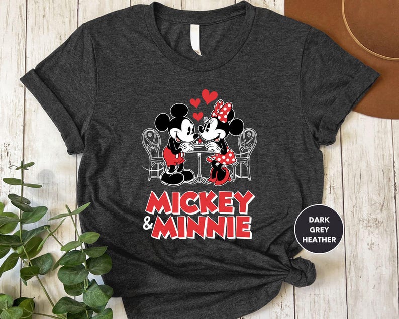 a mickey and minnie shirt sitting on top of a wooden table