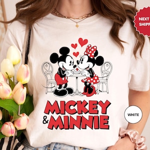 a woman wearing a mickey and minnie shirt