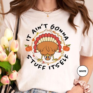 a woman wearing a t - shirt with a turkey on it