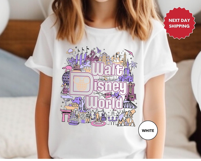 a young girl wearing a disney world tshirt