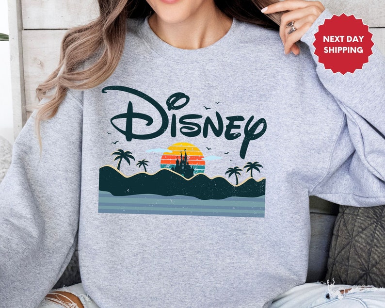 a woman wearing a sweatshirt with the disney logo on it