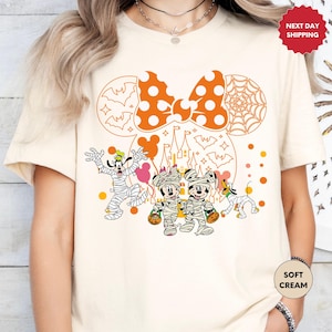 a woman wearing a mickey mouse halloween shirt