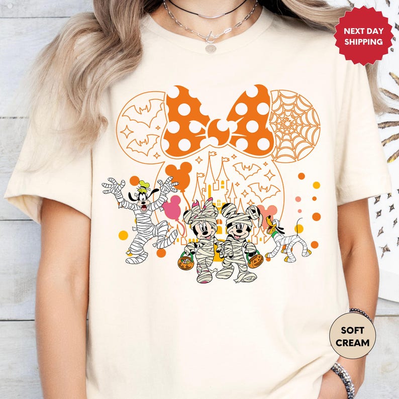 a woman wearing a mickey mouse halloween shirt