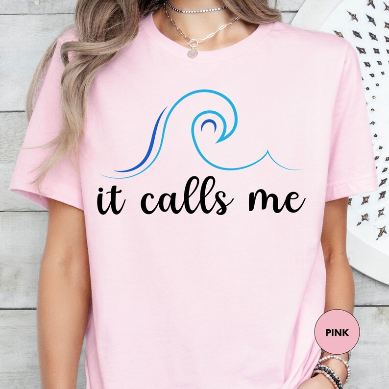 a woman wearing a pink shirt that says it calls me