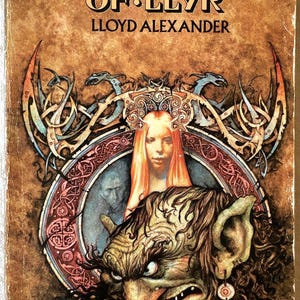 May include: Vintage book cover for "The Castle of Llyr" by Lloyd Alexander. The cover features a detailed illustration with a central portrait of a woman with red hair, surrounded by ornate designs and a grotesque creature. The title is prominently displayed.