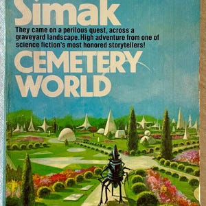 May include: A vintage paperback book cover for "Cemetery World" by Clifford D. Simak. The cover features a blue sky background with the title in large white letters. The artwork depicts a futuristic landscape with geometric structures and a robotic figure.