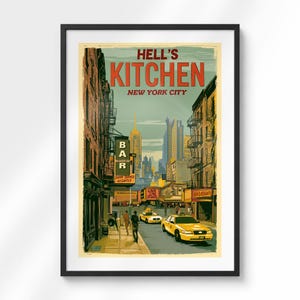 May include: A framed art print depicting a New York City street scene in Hell's Kitchen. The illustration features tall brick buildings, a yellow taxi cab, and a sign reading BAR. The text HELL'S KITCHEN NEW YORK CITY is printed in bold red letters at the top.