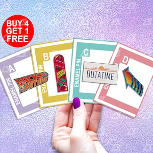 May include: Four enamel pins featuring Back to the Future themed imagery. The pins are displayed on cards with the letters A, B, C, and D. The pins depict the Back to the Future logo, a hoverboard, a license plate that reads "OUTATIME", and a time travel arrow.