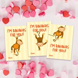 May include: Three Valentine's Day cards with the text "I'M BANANAS FOR YOU!" and a cartoon monkey illustration. The cards are yellow with vertical stripes and surrounded by pink and red heart-shaped candies.