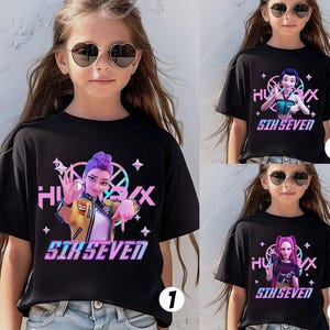 May include: Black t-shirts with colorful graphic designs. Each shirt features a different cartoon character with the text "HUX" and "SIX SEVEN". The designs include stars and geometric shapes.