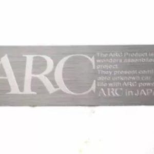 May include: A silver metal plate with the word "ARC" engraved in white. The plate also has the text "The ARC Product is wonders assembled. They present endless and unfaded car life with ARC power. ARC in JAPAN." engraved in white.