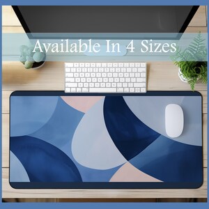 May include: A blue and white abstract design desk mat with a white computer mouse on top. Available in 4 sizes.