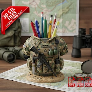 May include: A desk tidy in the shape of a military vest, with a camouflage pattern, holding pens and pencils. It features a rifle, grenades, and the word "COMMANDO". A red banner reads "3D STL FILES DIGITAL DOWNLOAD".