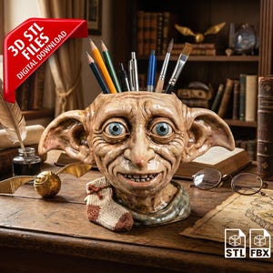May include: A detailed bust of a character with large blue eyes, used as a pencil holder, with pencils and brushes inside. A golden snitch, a feather, and a small sock are on the desk. The image includes the text "3D STL FILES DIGITAL DOWNLOAD".