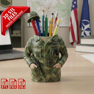 May include: A camouflage-patterned desk organizer shaped like a military uniform, holding pens and pencils. The organizer has a helmet on top and a rifle and radio on the front. The text "3D STL FILES DIGITAL DOWNLOAD" is on a red banner.