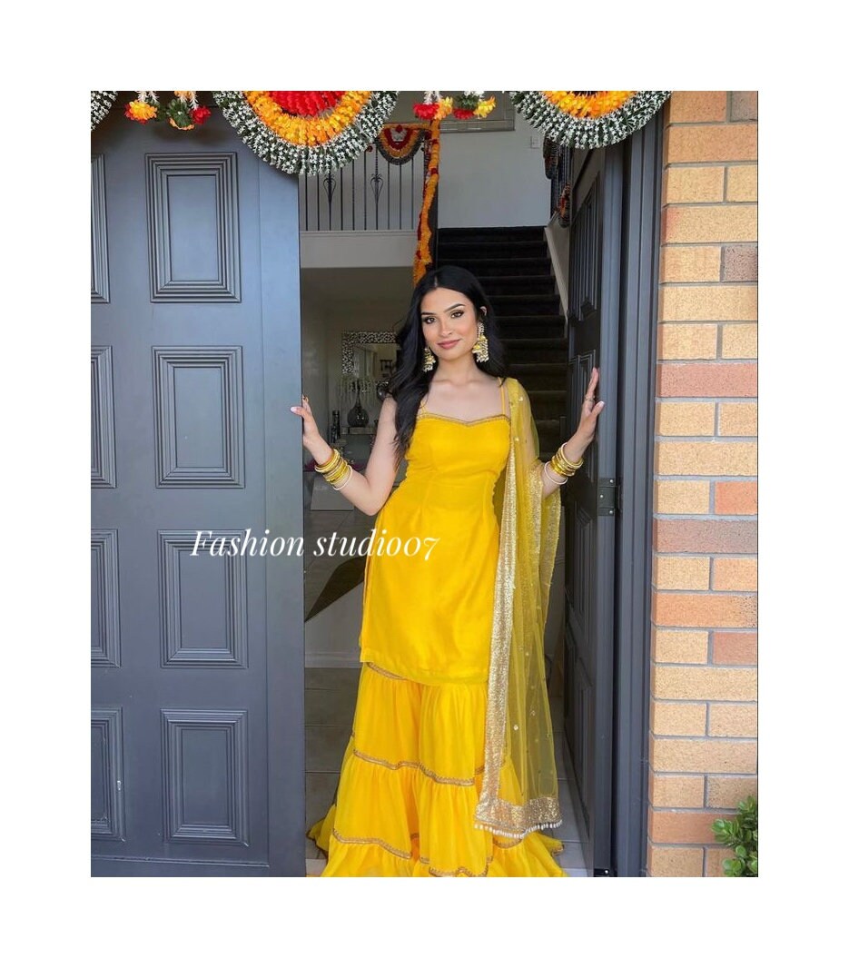 AMI109 - Party Wear Sharara Set in Yellow with Heavy Embroidery work. Comes with Pink Dupatta