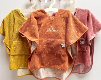 May include: Three hooded towels in yellow, orange, and pink with a white polka dot pattern. The orange towel has the name "Meline" embroidered on it.