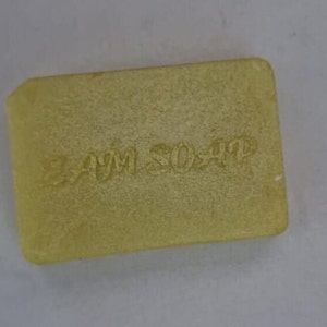 May include: A pale yellow bar of soap with the words "Bath Soap" embossed on the top.