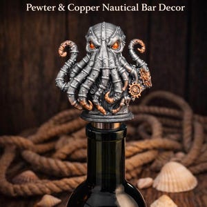 May include: Steampunk octopus wine stopper made of pewter and copper. The octopus has orange eyes and gear details. The stopper is on a dark wine bottle, with rope and seashells in the background.