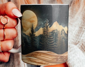May include: A white ceramic mug with a black and gold design featuring a full moon, mountains, and pine trees. The design has a woodgrain texture.