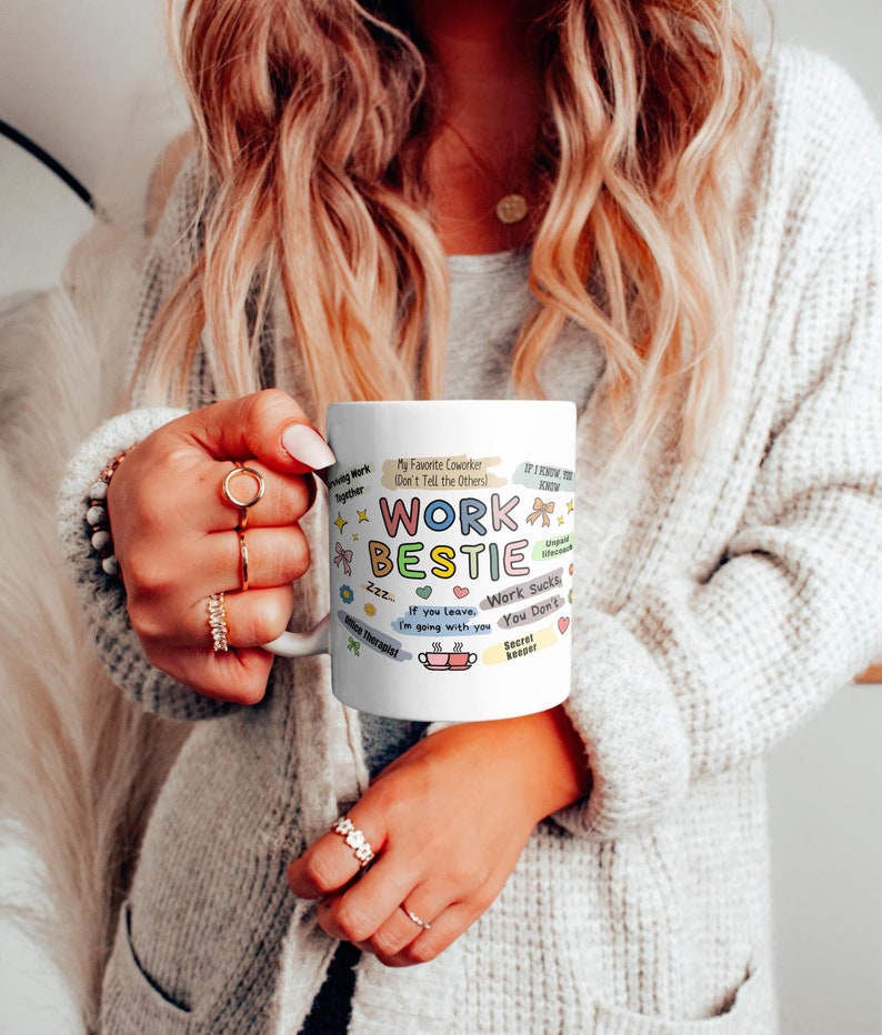 May include: White ceramic mug with a colorful design featuring the text "Work Bestie" and various illustrations related to work, such as a coffee cup, a clock, and a laptop. The text "My Favorite Coworker (Don't Tell the Others!)" is also included.
