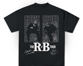 May include: Black t-shirt featuring the text "CHRIS USHER BROWN RAYMOND" in white, with images of two people. The text "THE R&B TOUR" is also displayed in white, along with two white signatures.