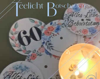 May include: A set of six tealight holders with floral designs and the number 60. The holders are white with a light blue and pink floral pattern. One holder has the text "Alles Liebe zum Geburtstag".