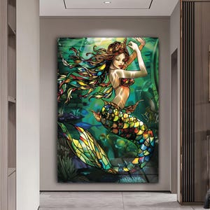 May include: A colourful stained glass mermaid with a green, blue and yellow tail. The mermaid is surrounded by green seaweed and fish.