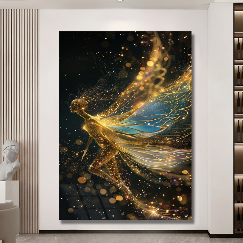 May include: A golden fairy with blue wings is depicted against a black background with sparkling gold glitter. The fairy is in flight with its wings spread wide.