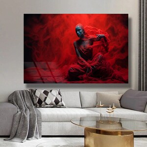 May include: A woman in a red, flowing fabric sits in a red, smoky background. The fabric is draped over her body, creating a dramatic and ethereal effect.