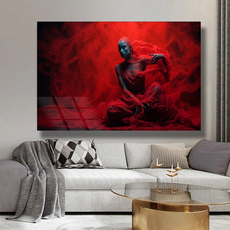 May include: A woman in a red, flowing fabric sits in a red, smoky background. The fabric is draped over her body, creating a dramatic and ethereal effect.