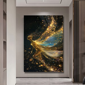May include: A golden fairy with blue and gold wings flies against a black background with sparkling gold glitter.