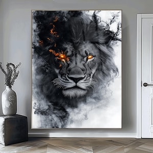 May include: A framed artwork featuring a lion's face with glowing orange eyes and a dark, smoky mane. The lion's fur is detailed in shades of gray and black, with wisps of smoke adding to the dramatic effect. The artwork is displayed on a wall.