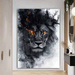 May include: A black and white lion art print. The lion's face is detailed with a smoky mane and fiery orange eyes. The artwork has a dramatic, artistic style, suitable for home decor.
