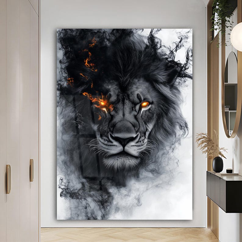 May include: A black and white lion art print. The lion's face is detailed with a smoky mane and fiery orange eyes. The artwork has a dramatic, artistic style, suitable for home decor.