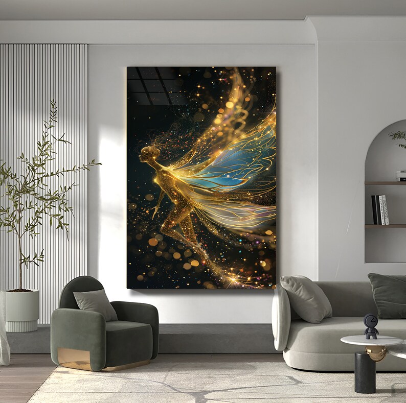 May include: A digital art print featuring a golden fairy with blue wings against a black background with gold glitter. The fairy is depicted with flowing hair and a delicate form.