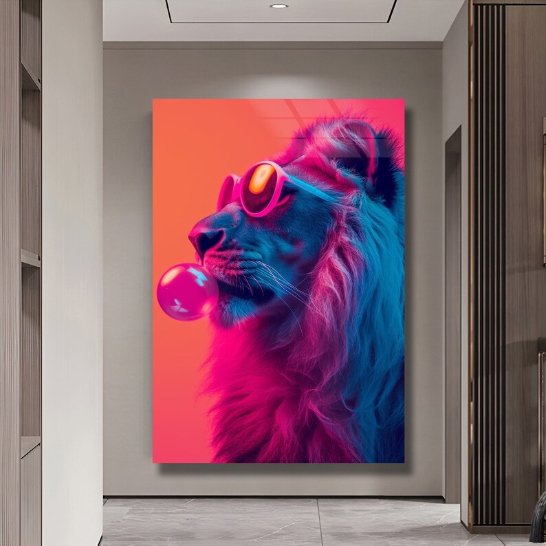May include: A rectangular wall art print featuring a profile view of a lion wearing pink-rimmed sunglasses and blowing a large, bright pink bubblegum bubble. The lion is rendered in vibrant neon shades of blue, purple, and orange against a solid background.