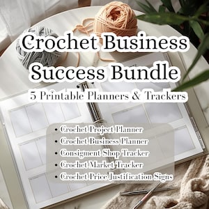 May include: A white binder with the text "Crochet Business Success Bundle" and "5 Printable Planners & Trackers." The bundle includes planners and trackers for crochet projects, business, consignment shops, markets, and price justification. Yarn and crochet hooks are also visible.